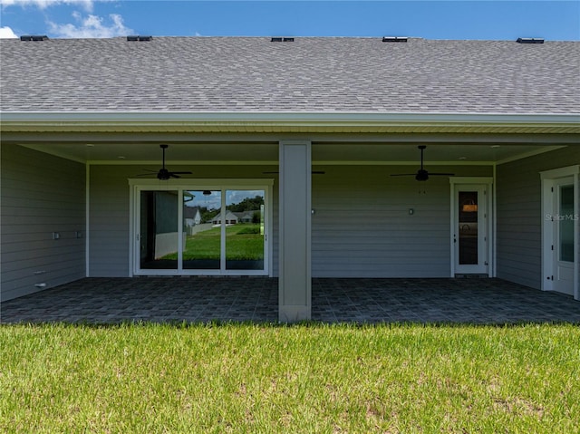 back of property featuring a yard, ceiling fan, and a patio area