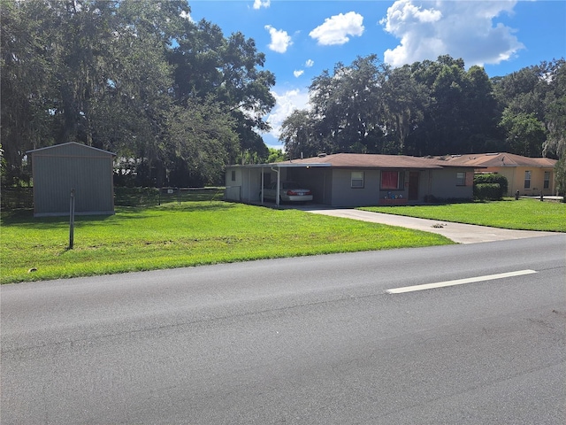 view of front of property with a carport and a front yard