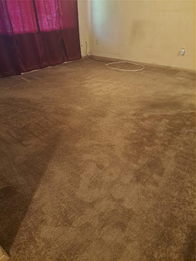 unfurnished room with carpet floors