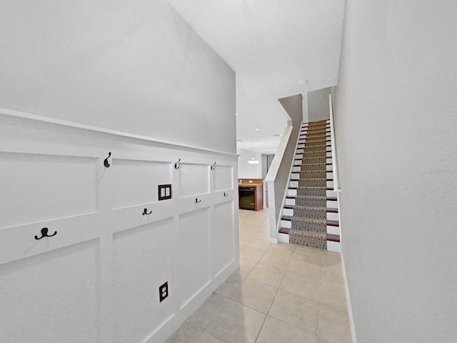 hall featuring light tile patterned flooring