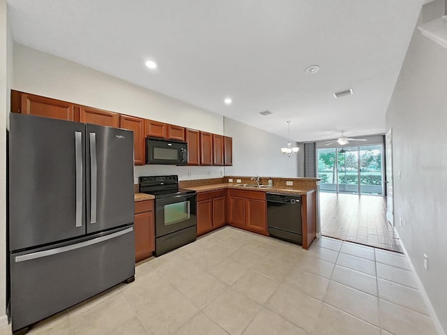 kitchen featuring pendant lighting, sink, light tile patterned floors, black appliances, and kitchen peninsula