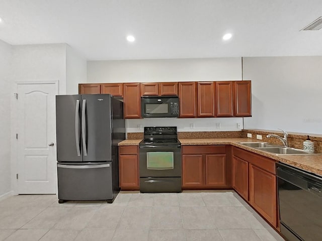 kitchen featuring light tile patterned floors, light stone countertops, sink, and black appliances