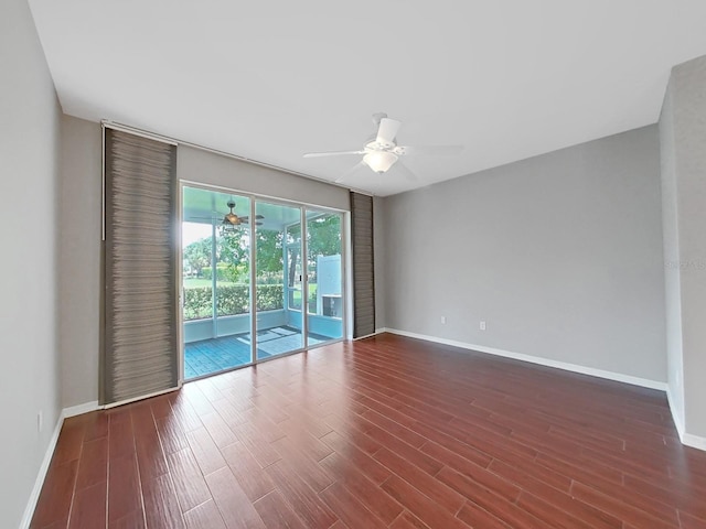 empty room with dark hardwood / wood-style floors and ceiling fan