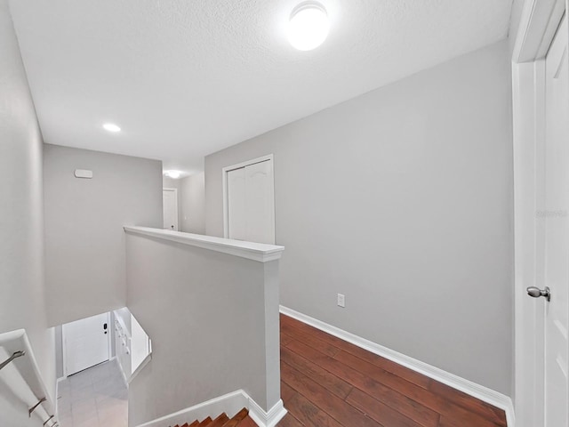 corridor with hardwood / wood-style floors