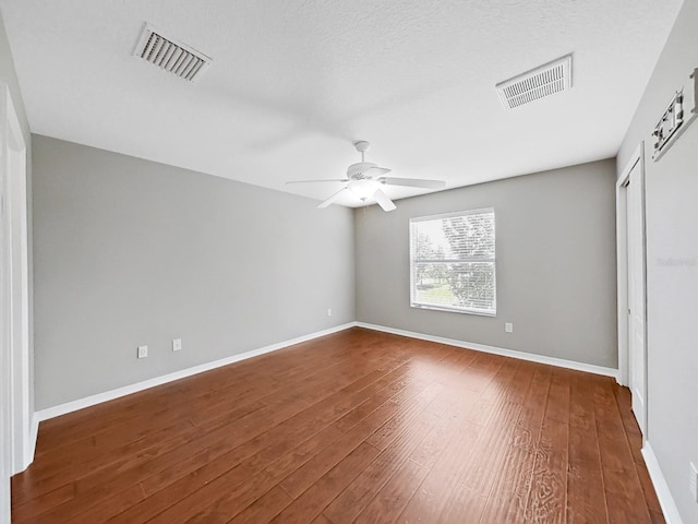 unfurnished bedroom featuring a textured ceiling, wood-type flooring, and ceiling fan