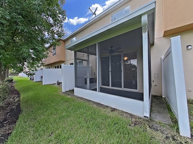 view of property exterior featuring a yard and a sunroom