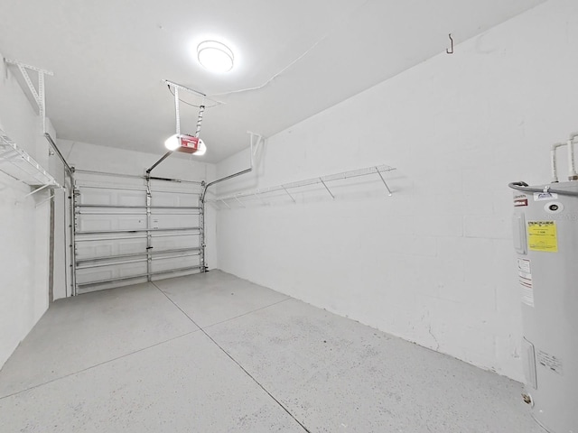 garage featuring a garage door opener and electric water heater