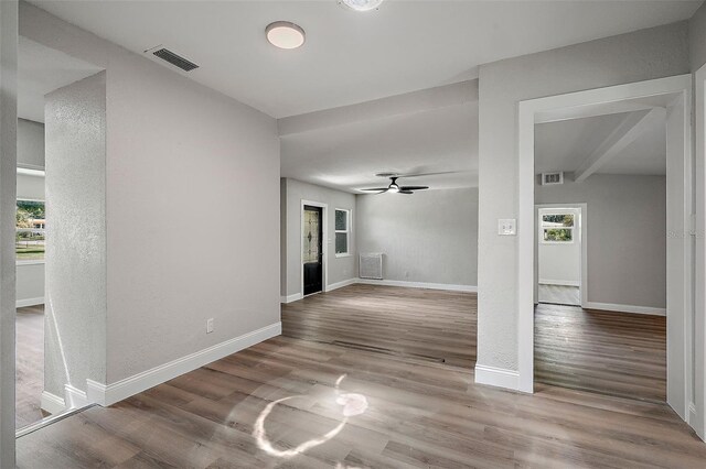 interior space featuring beam ceiling, ceiling fan, and hardwood / wood-style floors