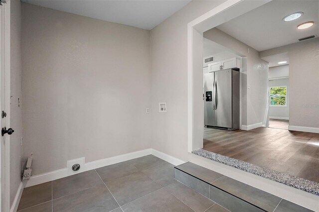 laundry area with hookup for a washing machine, hookup for an electric dryer, and hardwood / wood-style floors