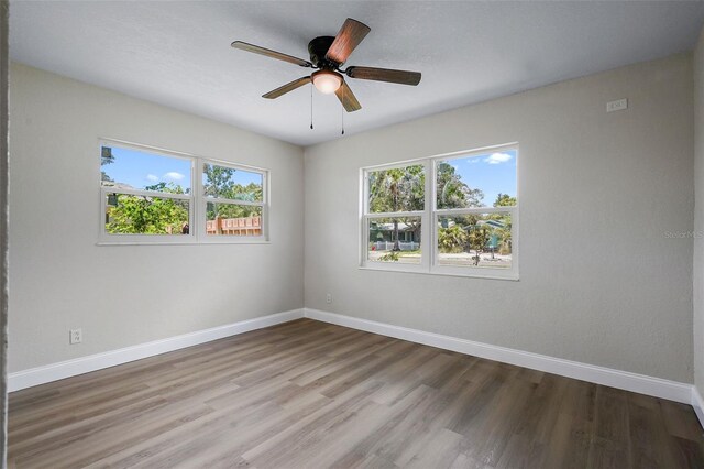 empty room featuring wood-type flooring and ceiling fan