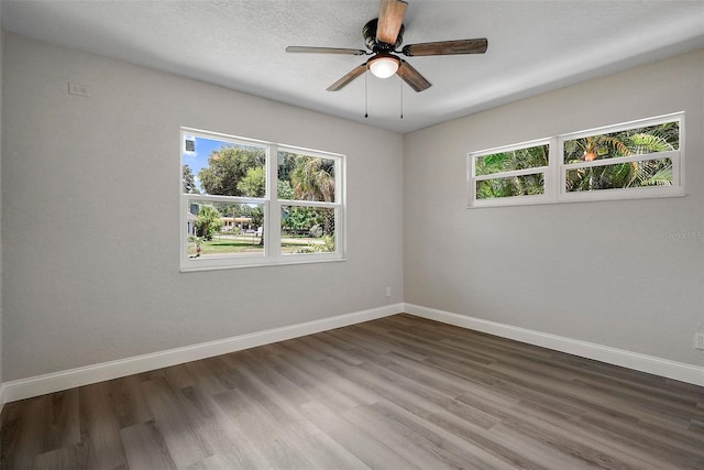 spare room featuring hardwood / wood-style floors and ceiling fan