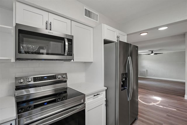 kitchen with decorative backsplash, appliances with stainless steel finishes, ceiling fan, and wood-type flooring