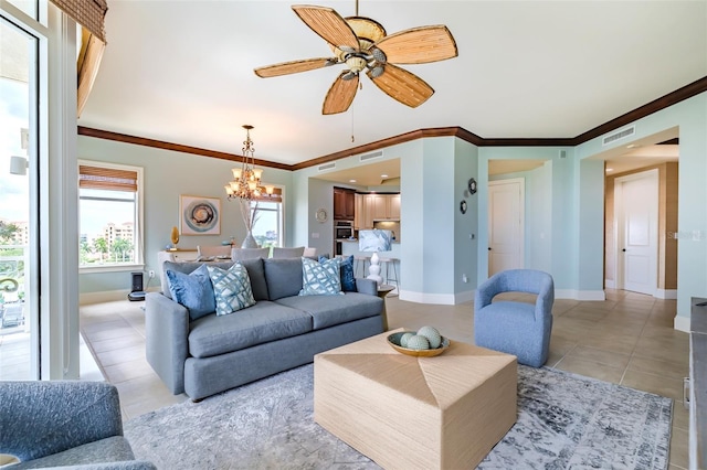 living area with light tile patterned floors, baseboards, visible vents, crown molding, and ceiling fan with notable chandelier