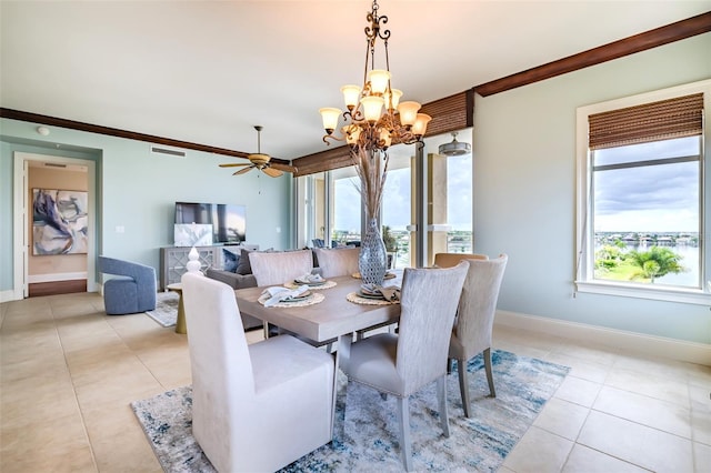 dining area featuring ornamental molding, light tile patterned flooring, baseboards, and ceiling fan with notable chandelier