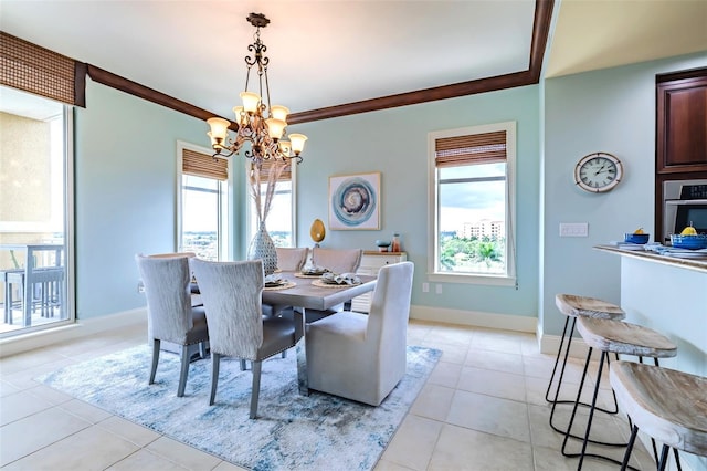 dining space featuring baseboards, ornamental molding, light tile patterned flooring, and a notable chandelier