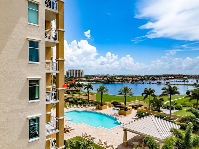 community pool featuring a water view and a patio