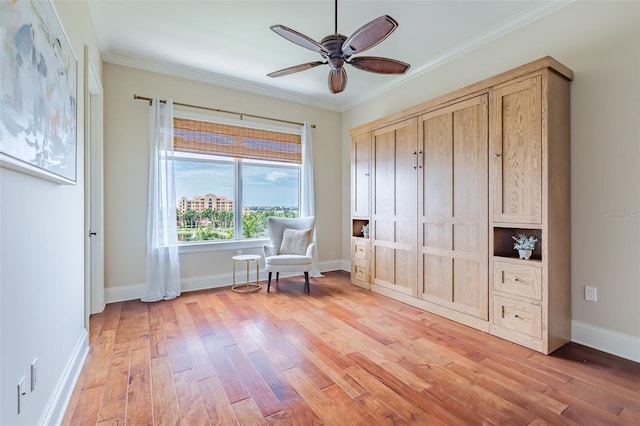 unfurnished room with baseboards, ceiling fan, light wood-type flooring, and crown molding