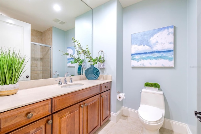 full bathroom featuring a stall shower, baseboards, toilet, tile patterned floors, and vanity