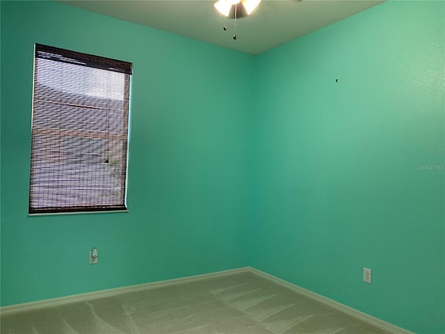 empty room with ceiling fan and carpet floors