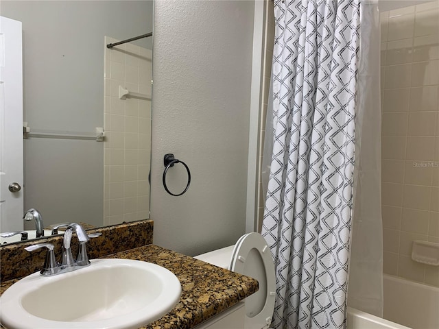 full bathroom featuring shower / bath combo, toilet, and vanity