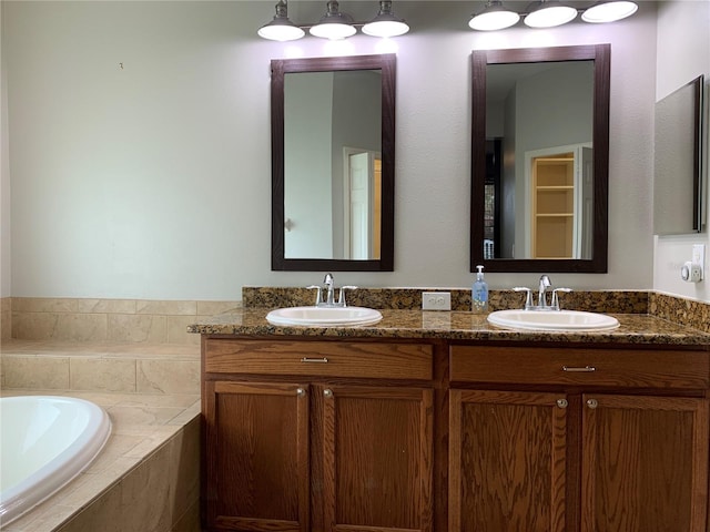 bathroom with vanity and a relaxing tiled tub