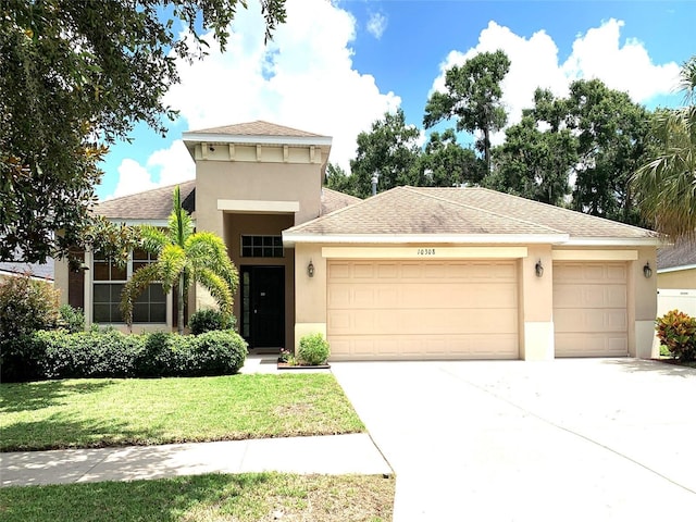 view of front facade featuring a front lawn and a garage