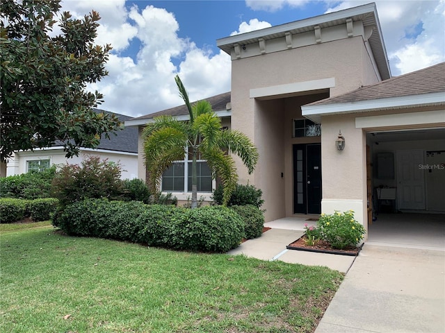 entrance to property featuring a yard