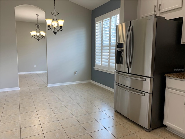 kitchen with white cabinetry, light tile patterned floors, an inviting chandelier, hanging light fixtures, and stainless steel fridge with ice dispenser