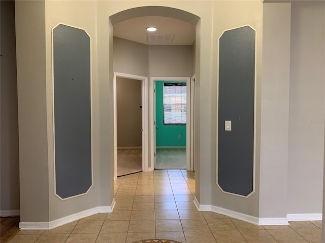 hall with light tile patterned floors