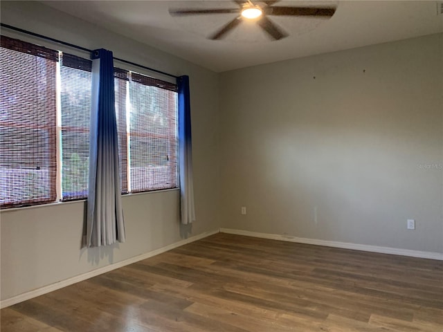 unfurnished room featuring a healthy amount of sunlight, ceiling fan, and hardwood / wood-style flooring