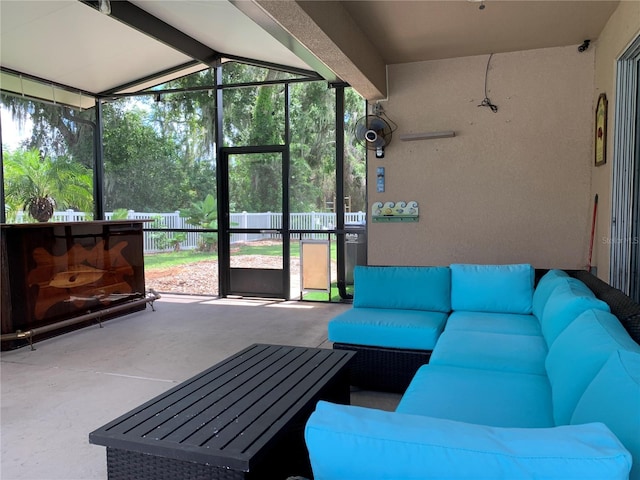 sunroom / solarium featuring a wealth of natural light and vaulted ceiling with beams