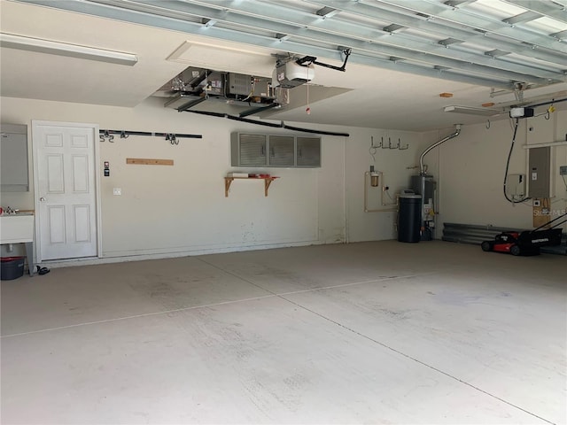 garage with a garage door opener and water heater