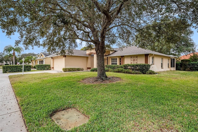 ranch-style house featuring a garage and a front yard