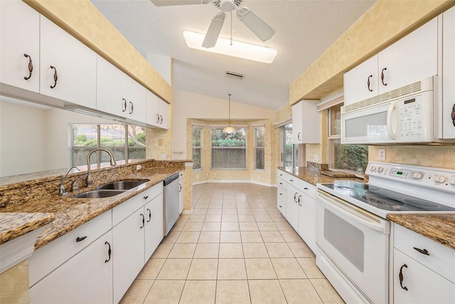 kitchen with a textured ceiling, white cabinetry, sink, and white appliances