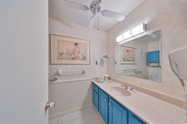 bathroom with vanity, a textured ceiling, tile patterned flooring, and ceiling fan