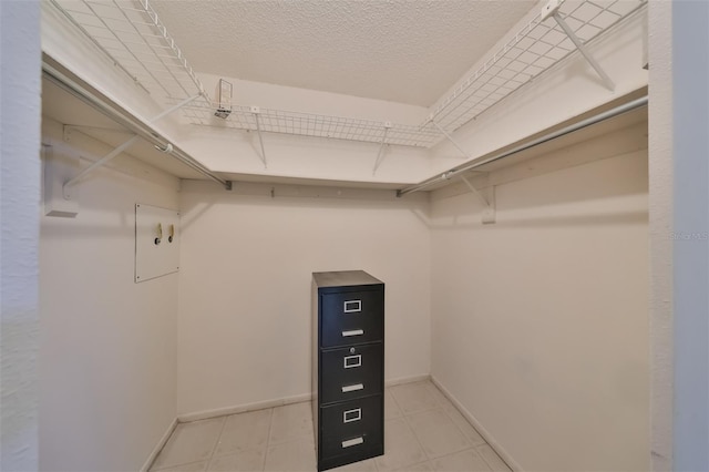 spacious closet featuring light tile patterned flooring