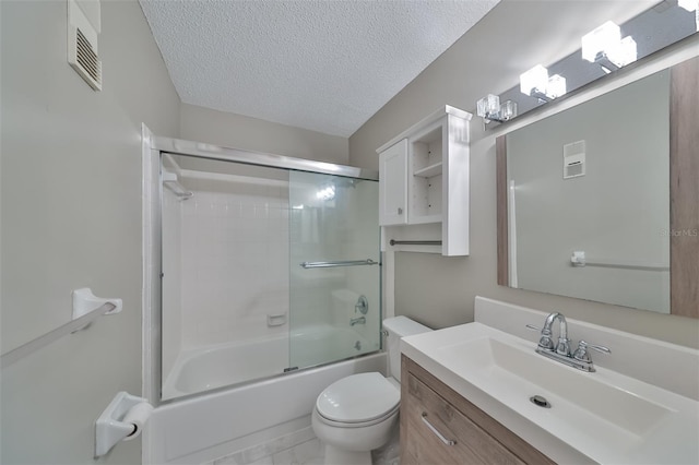 full bathroom featuring combined bath / shower with glass door, a textured ceiling, tile patterned floors, toilet, and vanity