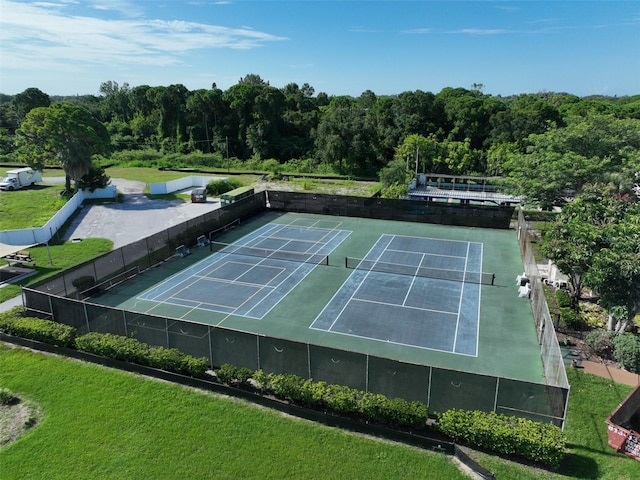 view of tennis court with a lawn