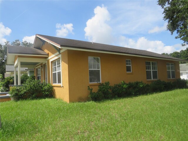 view of side of property with a yard