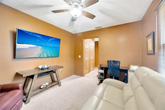 carpeted living room with ceiling fan