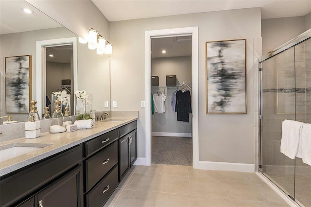 bathroom with vanity, a shower with door, and tile patterned floors