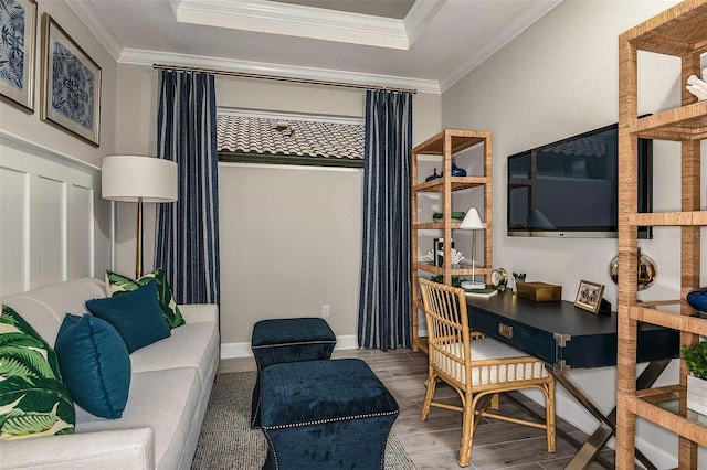 office area featuring hardwood / wood-style flooring, a tray ceiling, and crown molding