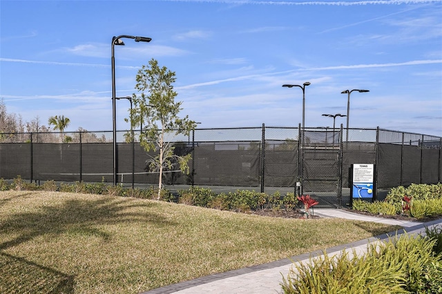 view of sport court with a yard