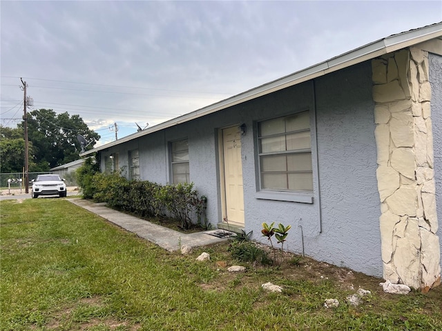 view of property exterior with a yard