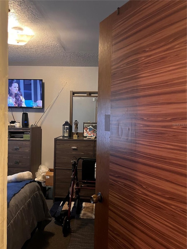 carpeted bedroom featuring a textured ceiling