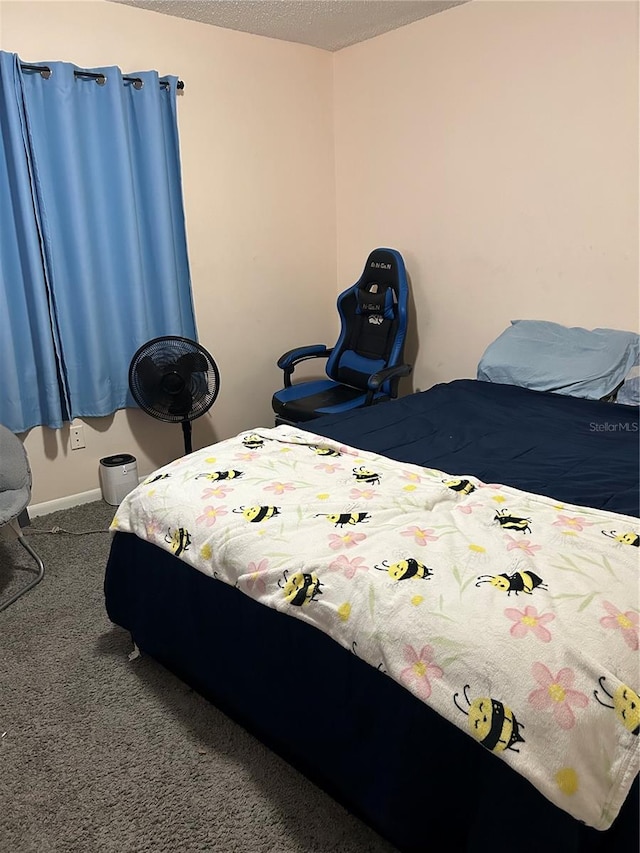 bedroom with a textured ceiling and carpet