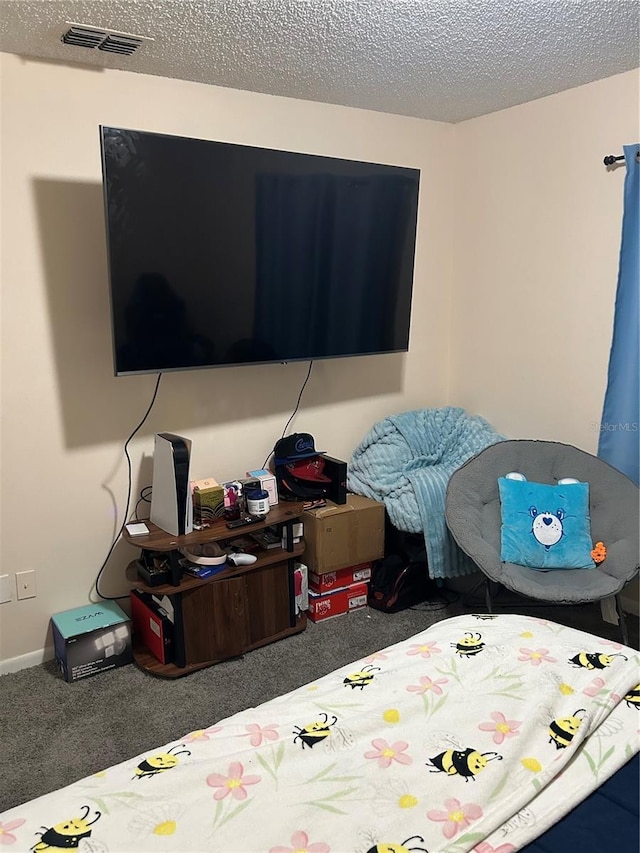 carpeted bedroom featuring visible vents and a textured ceiling