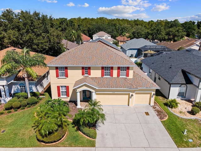 view of front of property with a garage and a front yard