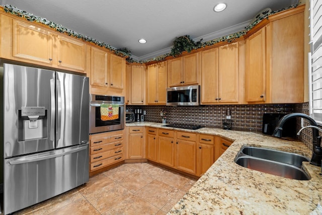 kitchen with light stone countertops, stainless steel appliances, ornamental molding, and sink