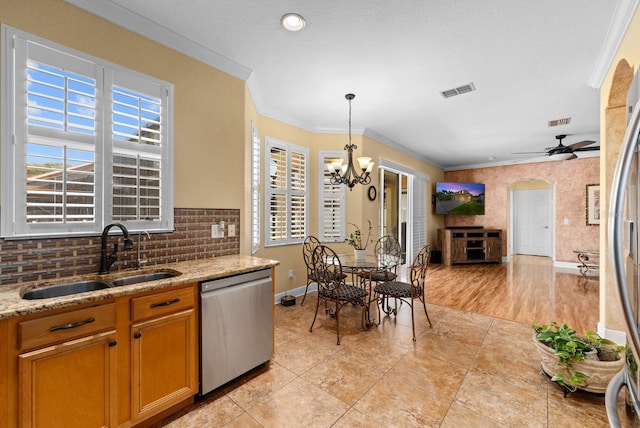 kitchen featuring ornamental molding, sink, decorative light fixtures, stainless steel appliances, and ceiling fan with notable chandelier